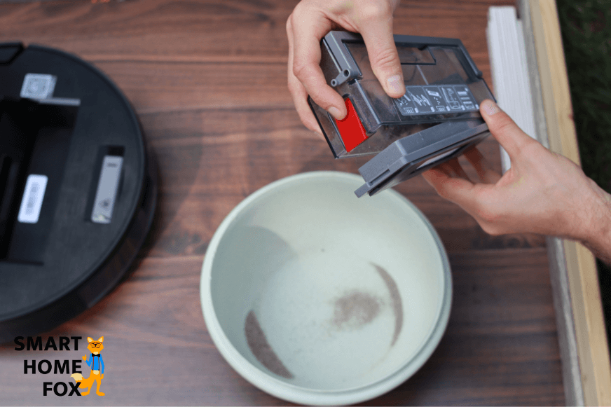 Emptying the mobile dustbin of the Ecovacs Deebot OZMO 950 above the trash.